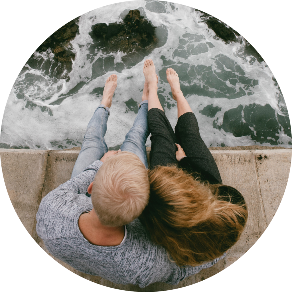 Couple holding hands on beach - circle