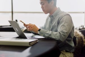 Man at Work on Computer and Phone - Alpha Male Personality