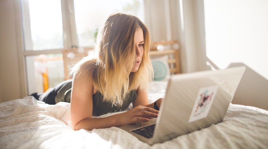 Woman in Bed on Computer - Online Dating